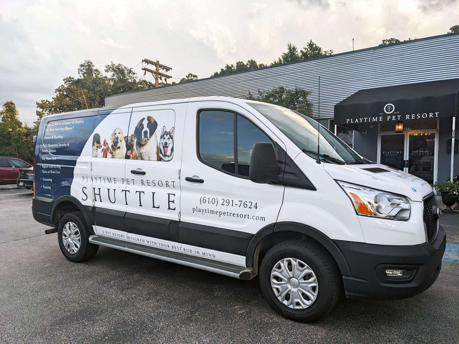 Angled image of one side of the Playtime Pet Resort shuttle van