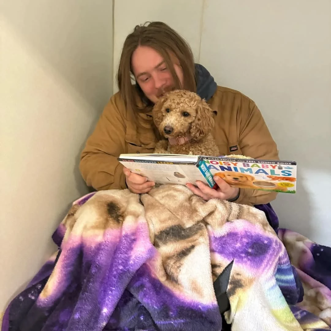dog getting a bed time story